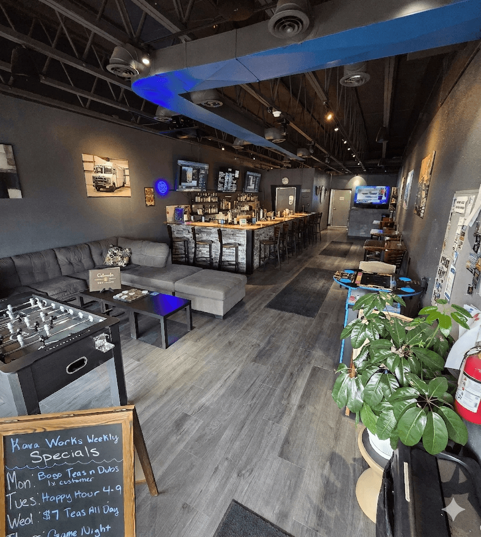 A bright kava bar lounge with seating, games, and a long bar